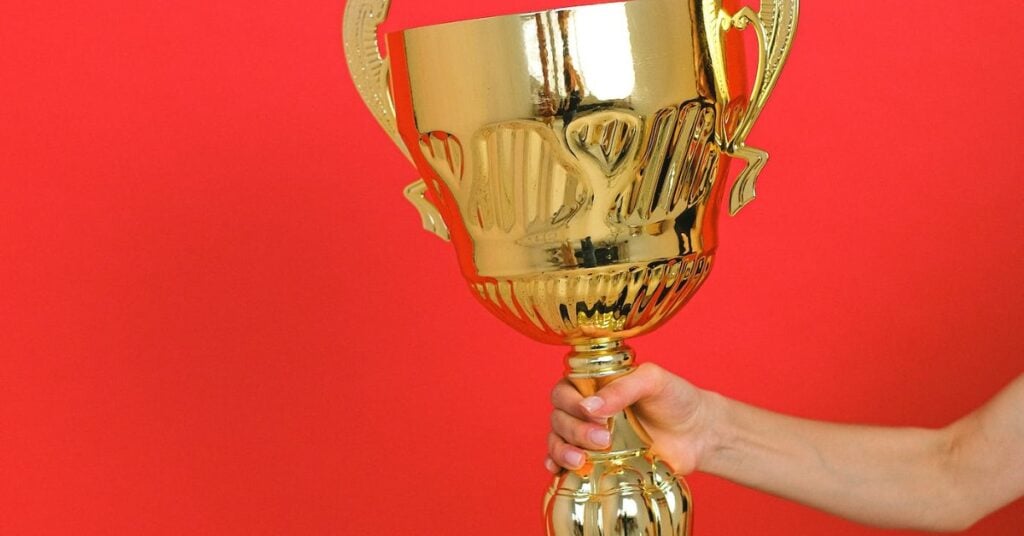 Person holding a huge trophy.